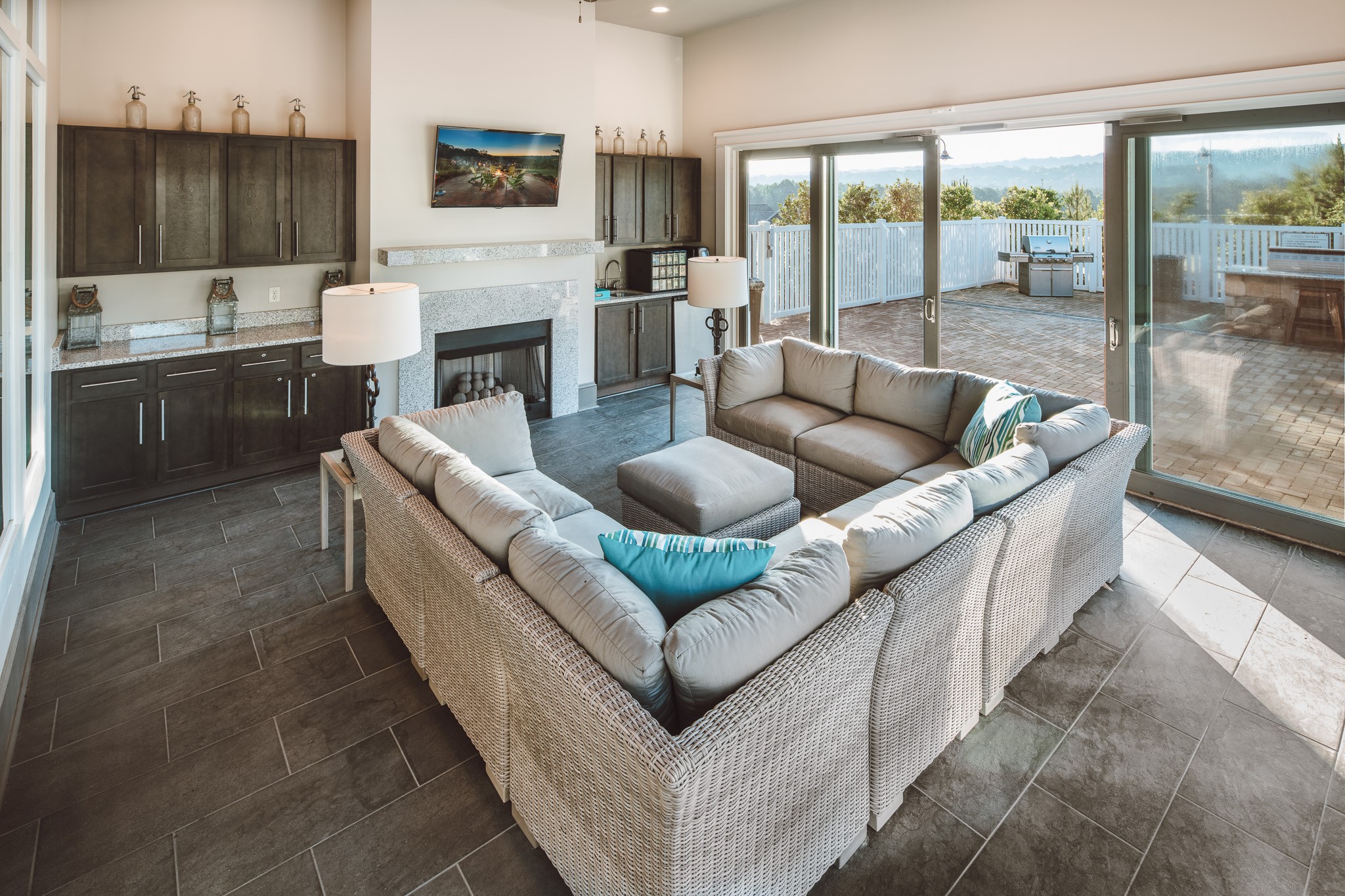 A living room with a large couch and a fireplace.