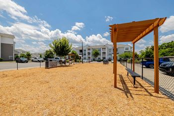 a park with a picnic area and a fence at Concord Ridge Apartments, Concord, NC