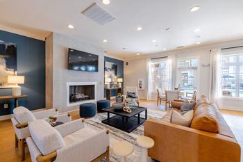 a living room with couches and chairs and a fireplace at Concord Ridge Apartments, Concord