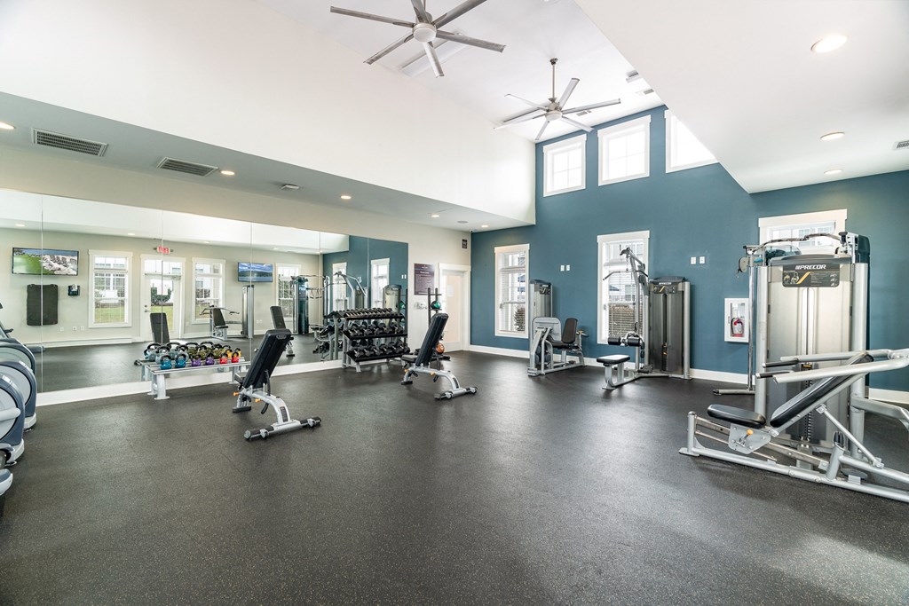A gym with a variety of equipment including weights and cardio machines. at Concord Ridge Apartments, Concord