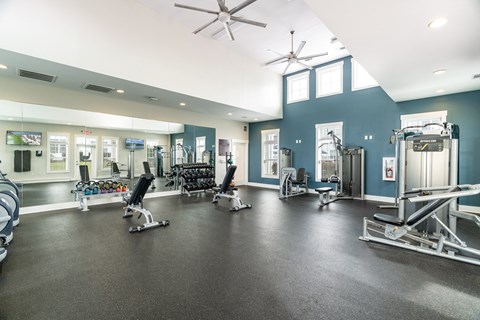 A gym with a variety of equipment including weights and cardio machines. at Concord Ridge Apartments, Concord