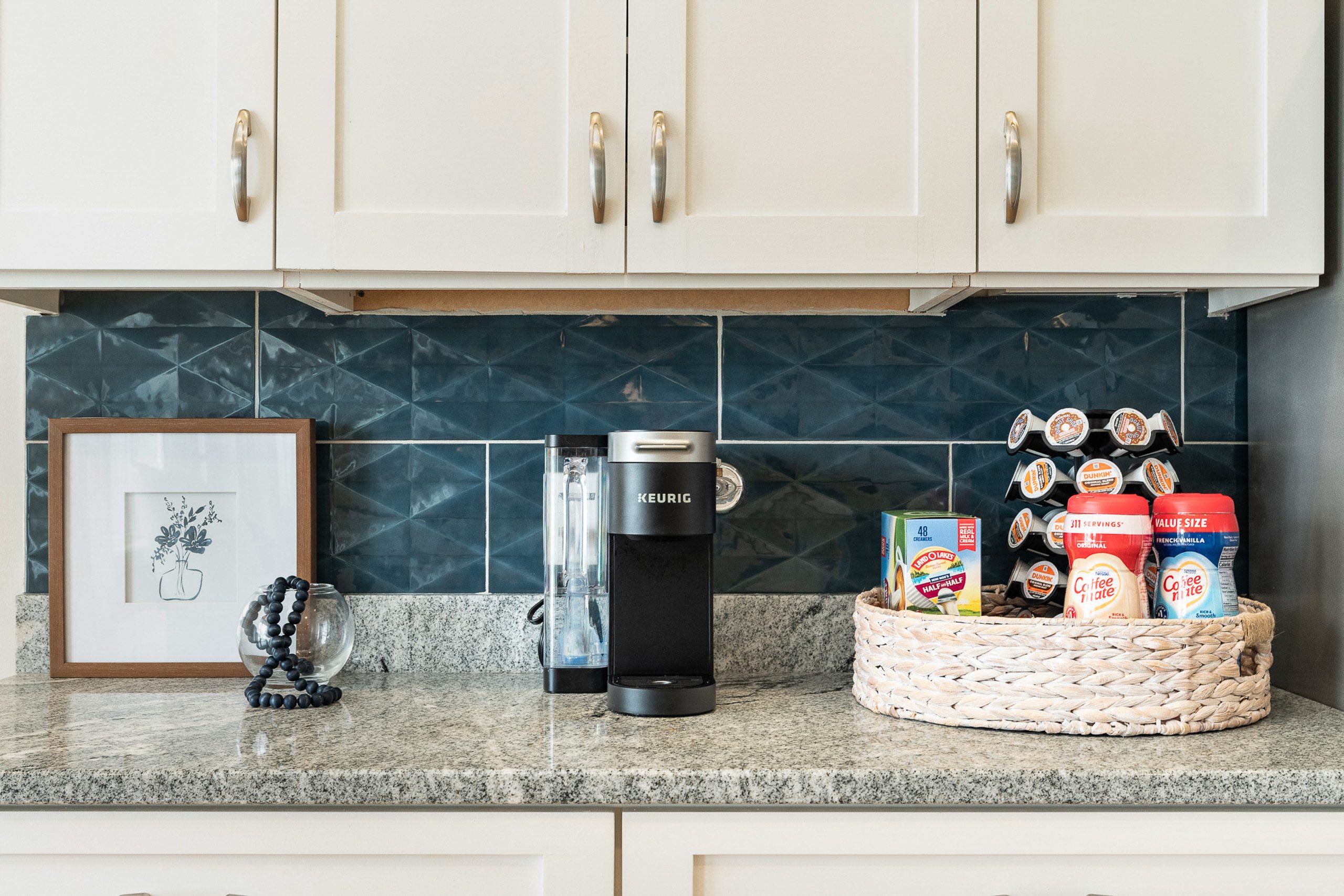 A kitchen counter with a basket of food and a coffee maker.