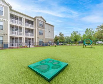 a green yard with a yoga mat at Terraces at Town Center, Jacksonville