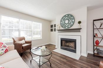 A living room with a fireplace and a couch. at WildForest Apartments, Birmingham, Alabama