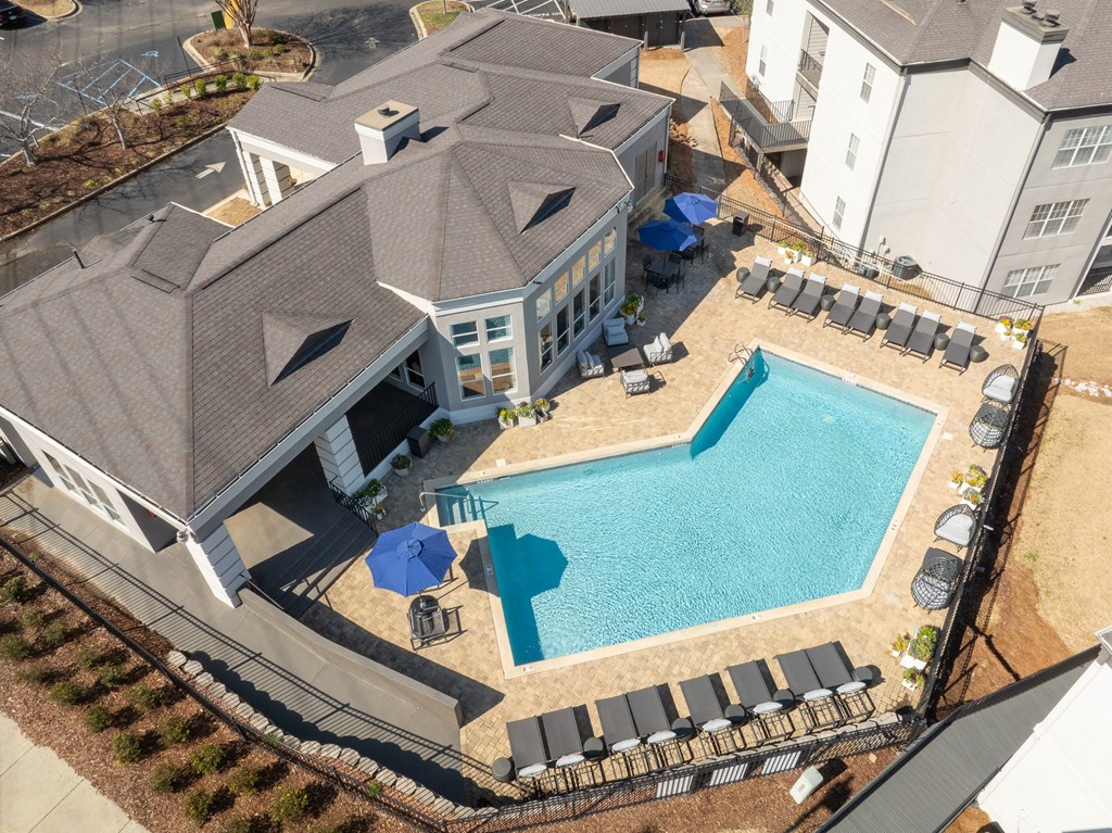 an aerial view of a large swimming pool in front of a house at WildForest Apartments, Birmingham, AL
