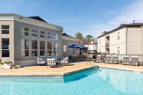 swimming pool with chairs and umbrellas swimming pool with chairs and umbrellas at WildForest Apartments, Alabama