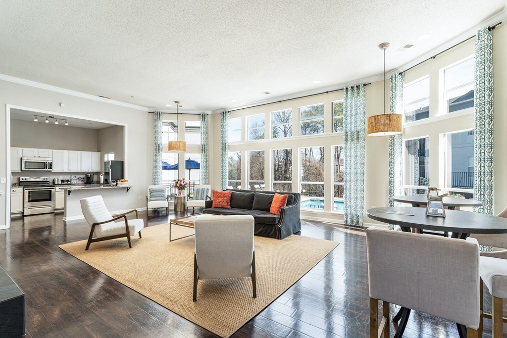 a living room with a couch and chairs and a table at WildForest Apartments, Birmingham, 35209