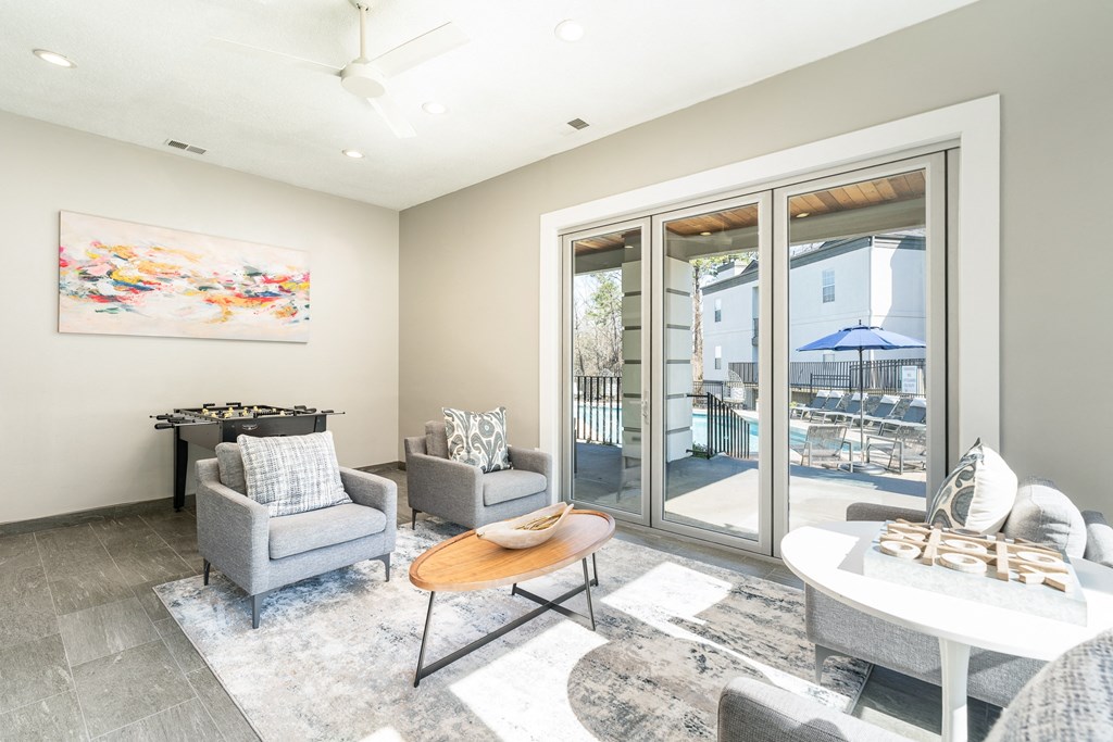 a living room with a table and chairs and sliding glass doors at WildForest Apartments, Birmingham, AL