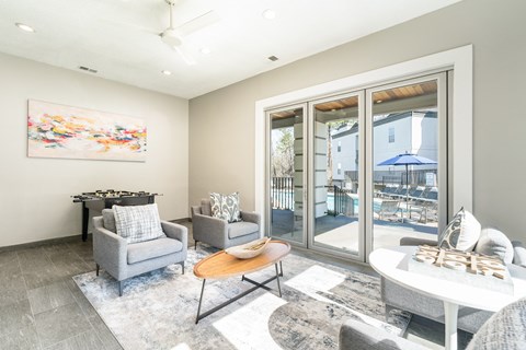 a living room with a table and chairs and sliding glass doors a living room with a table and chairs and sliding glass doors at WildForest Apartments, Birmingham, AL