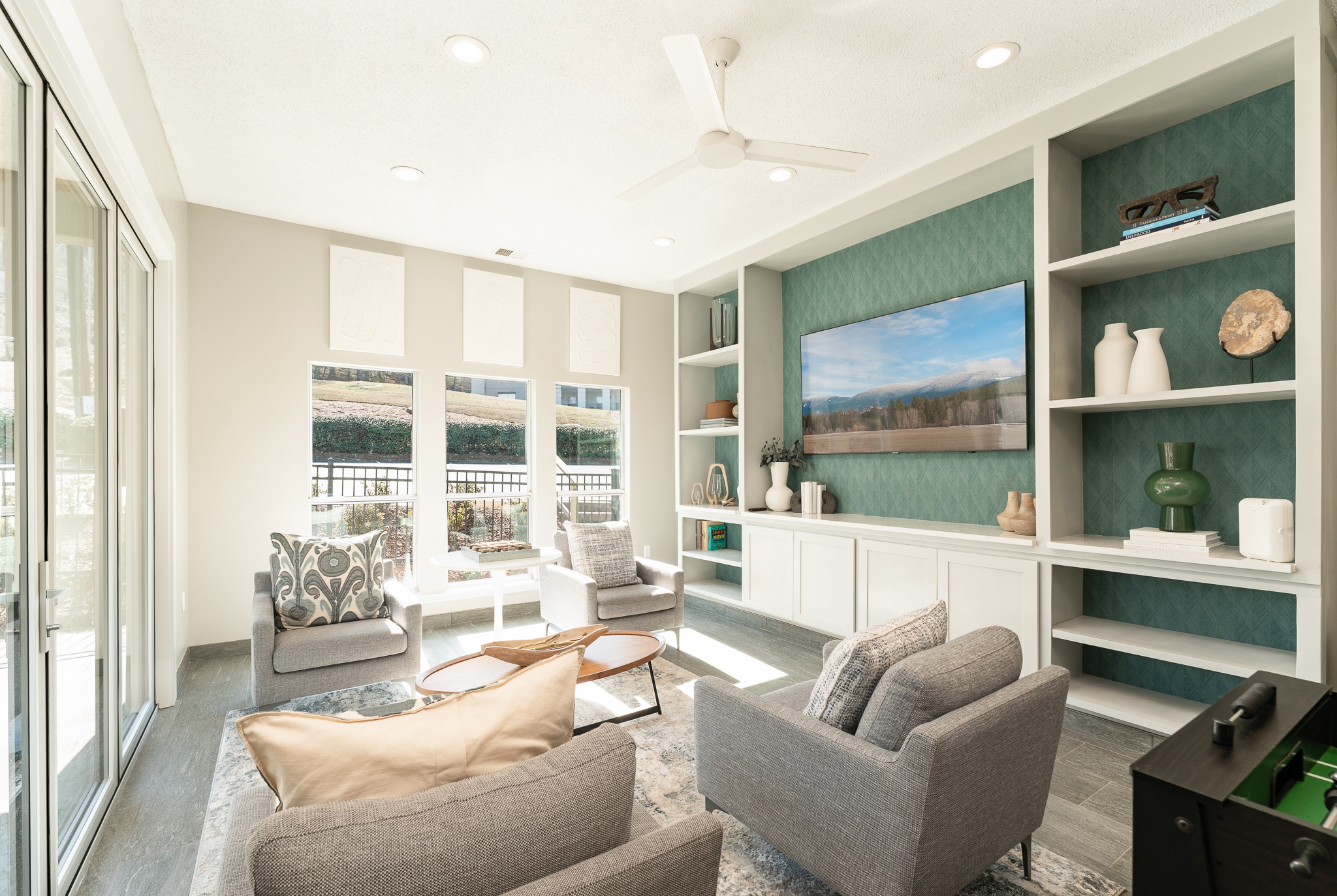 a living room with a couch and chairs and a television