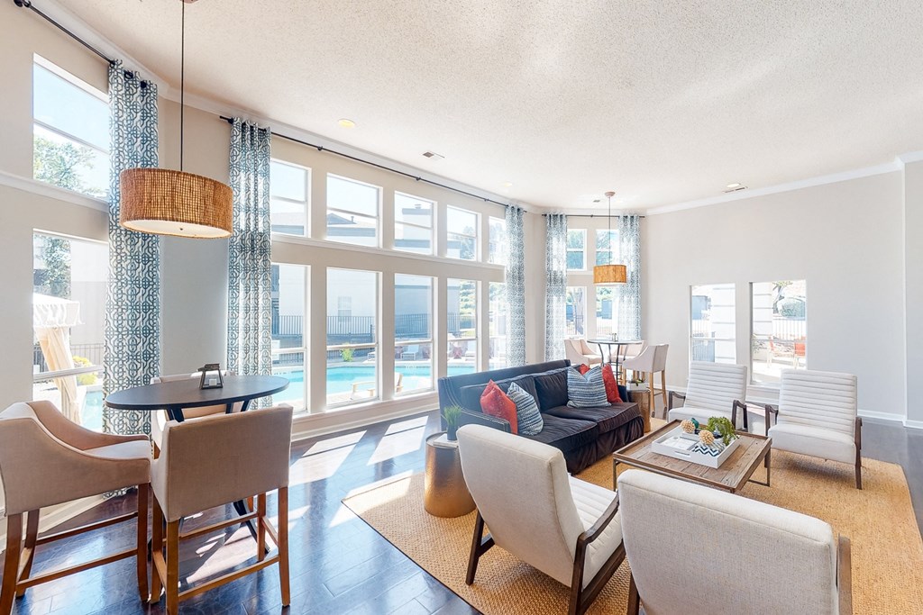 a living room with a couch and a table with chairs at WildForest Apartments, Alabama, 35209
