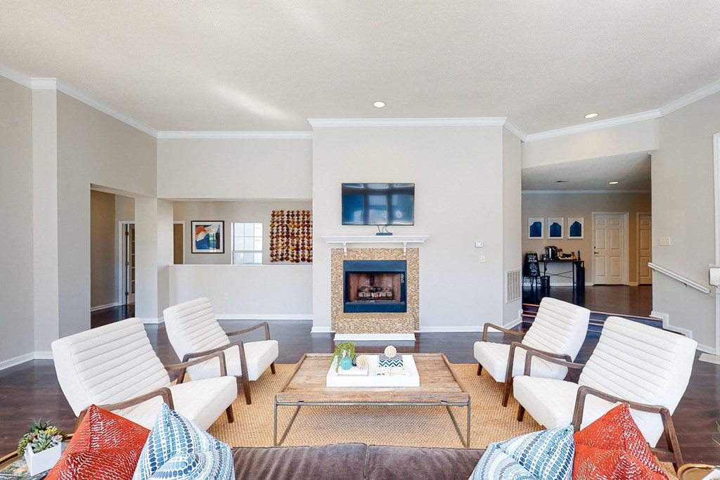 a living room with white furniture and a fireplace at WildForest Apartments, Alabama