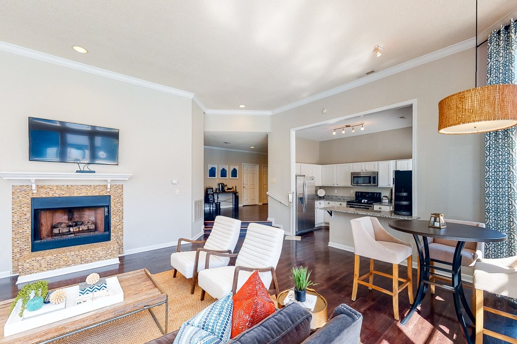 a living room with a fireplace and a kitchen with a table and chairs at WildForest Apartments, Birmingham
