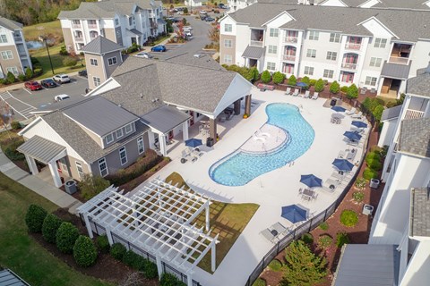 An aerial view of at Concord Ridge Apartments, Concord, NC with a pool in the foreground.