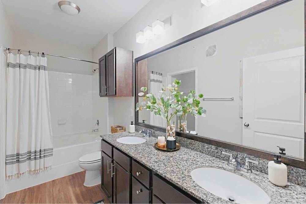 A bathroom with a white sink and a mirror.at Pecan Springs, Texas
