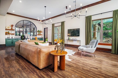 A living room with a brown sofa and a wooden table.