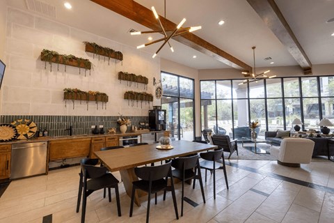 A modern kitchen with a wooden table and chairs.