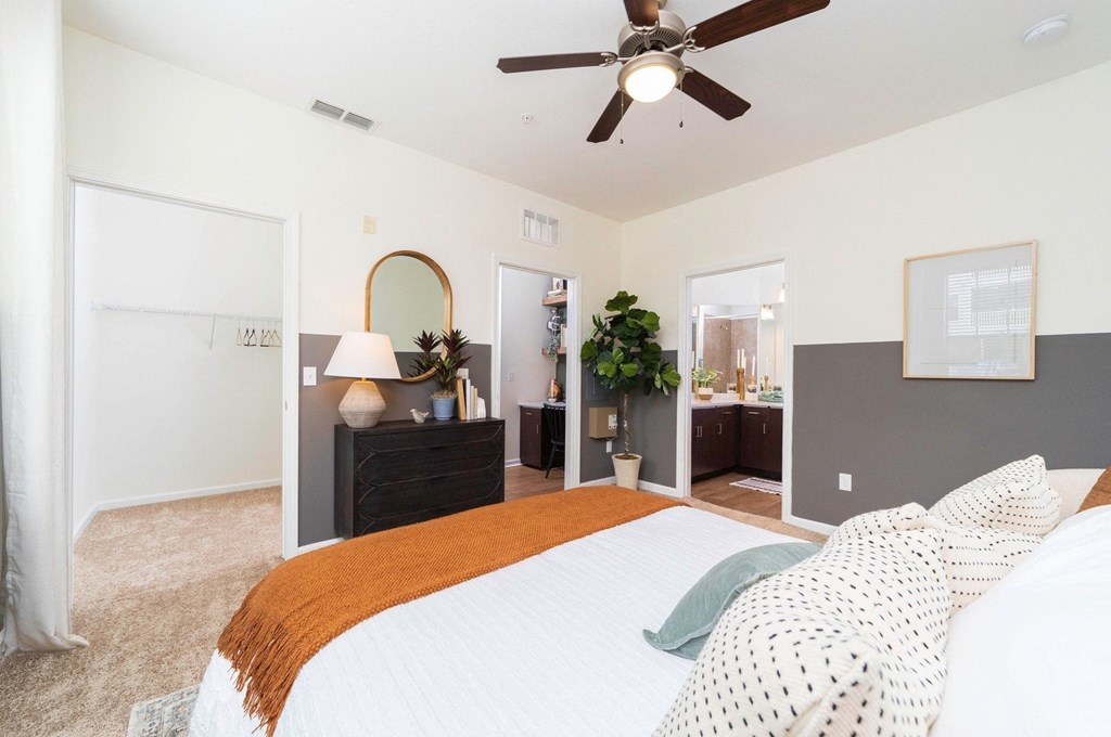 a bedroom with a large bed and a ceiling fan a bedroom with a large bed and a ceiling fan at Terraces at Town Center, Jacksonville, 32256
