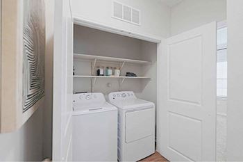 A small laundry room with a washer and dryer.