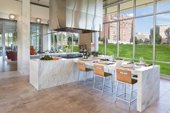 a kitchen with a large island with a breakfast bar in front of a large window