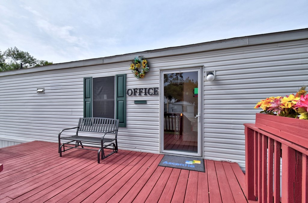 Bench and a wooden deck in front of office at Country Oaks, San Antonio, TX