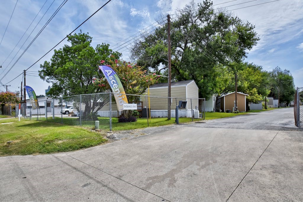 a house with a sign on the side of a road