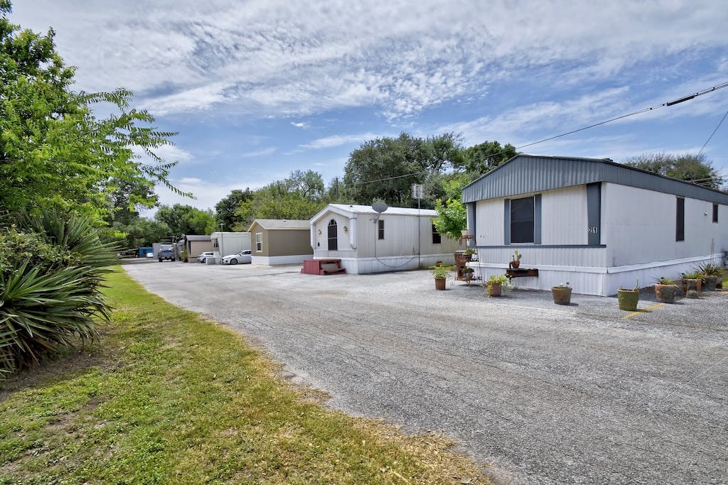 a white house with a gravel road in front of it
