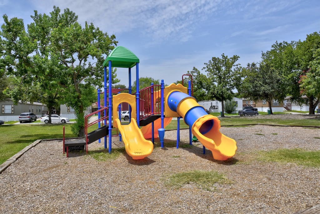 a playground with a yellow and blue slide