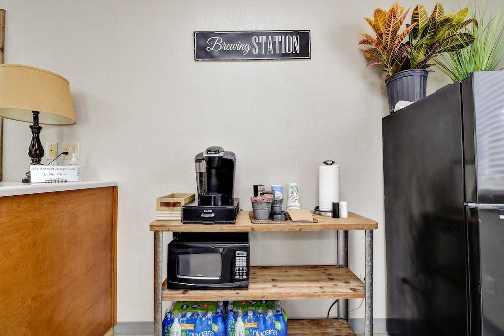 a small kitchen with a microwave and a refrigerator