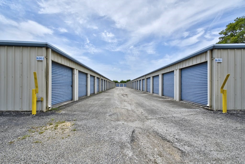 a row of garages with blue and white doors