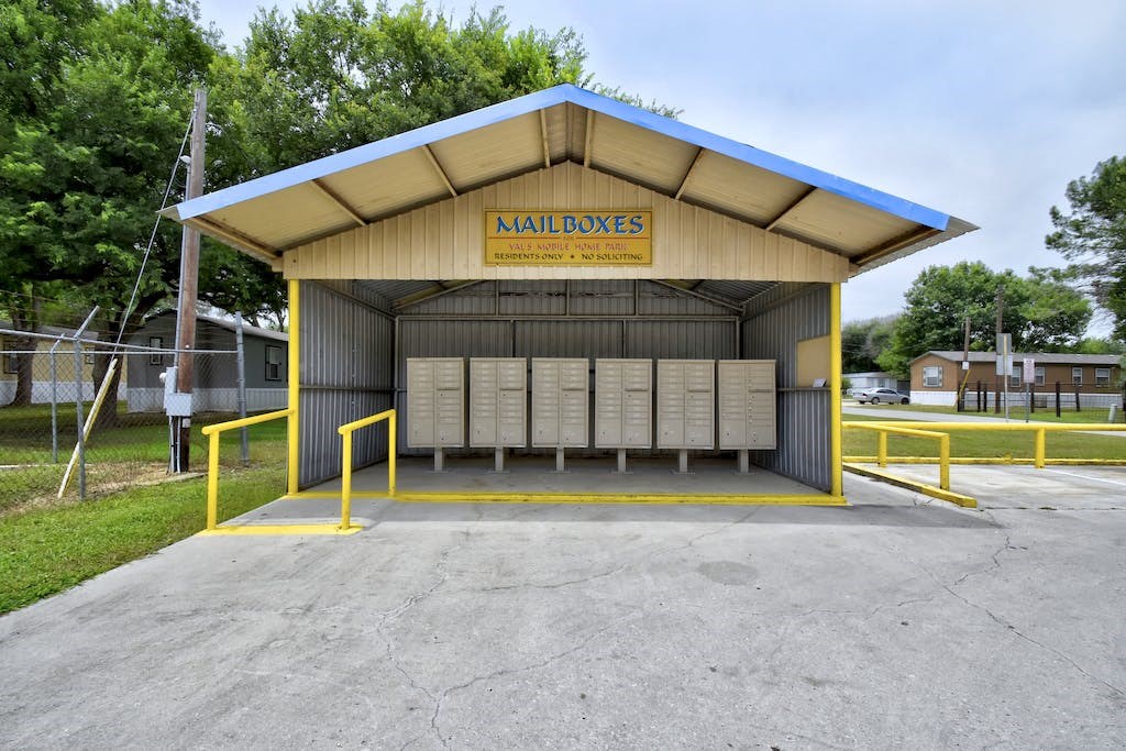 a parking lot with a kiosk with benches in it