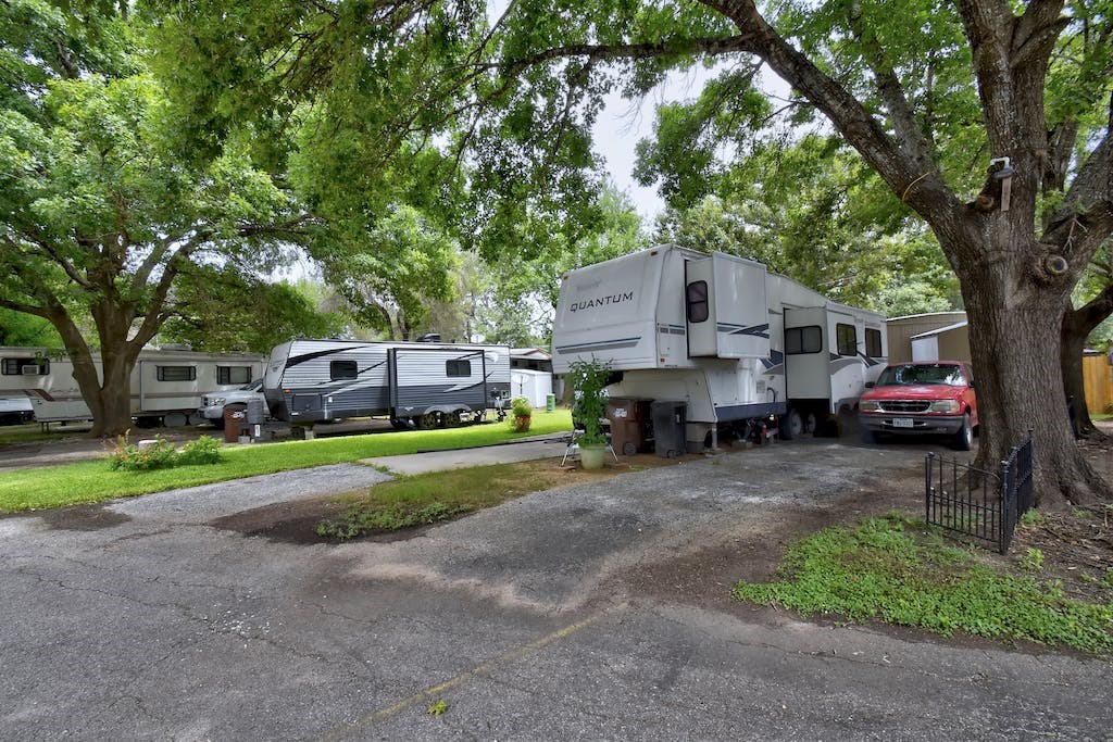 an trailer parked in a parking lot with trees