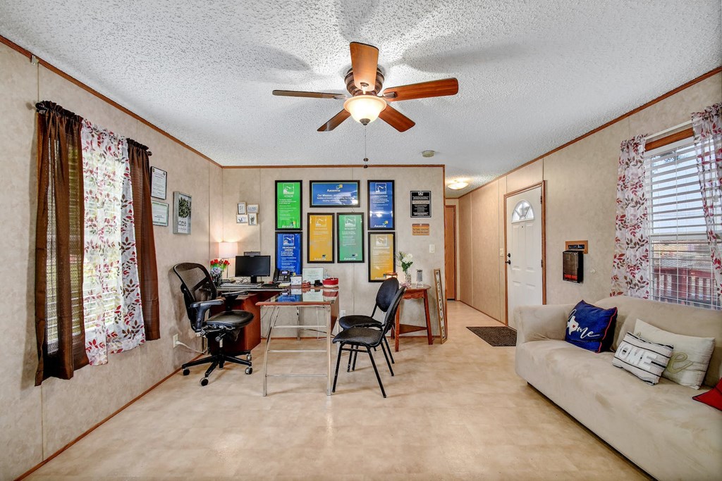 a living room filled with furniture and a ceiling fan