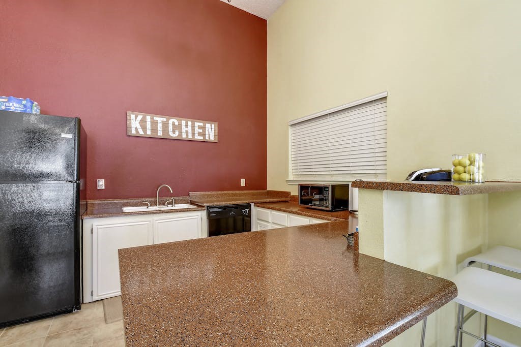 a kitchen with a counter top and a refrigerator