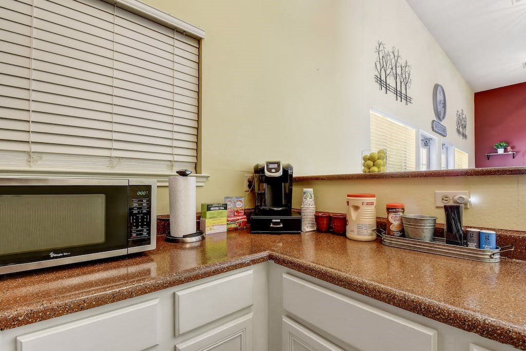 a kitchen with a counter top and a microwave