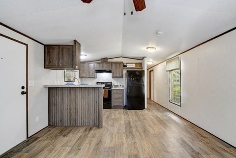 a kitchen with a refrigerator and a sink