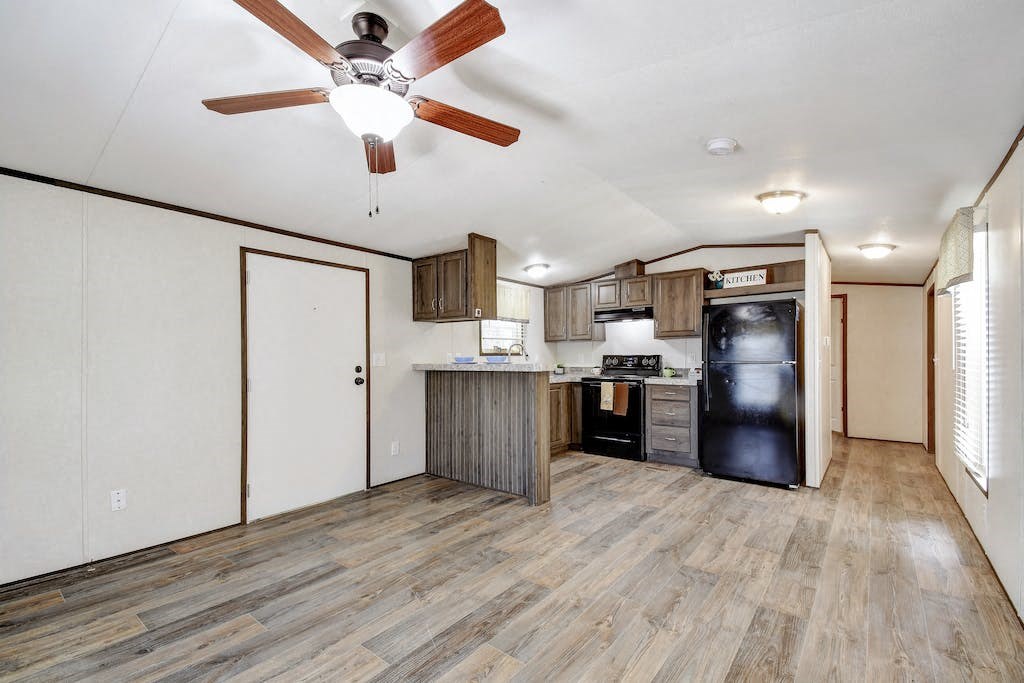 a kitchen with a ceiling fan and a refrigerator