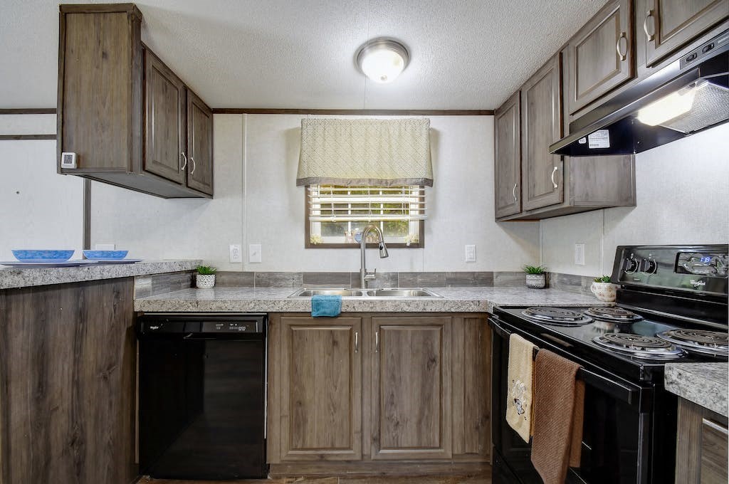 a kitchen with a stove top oven and a sink