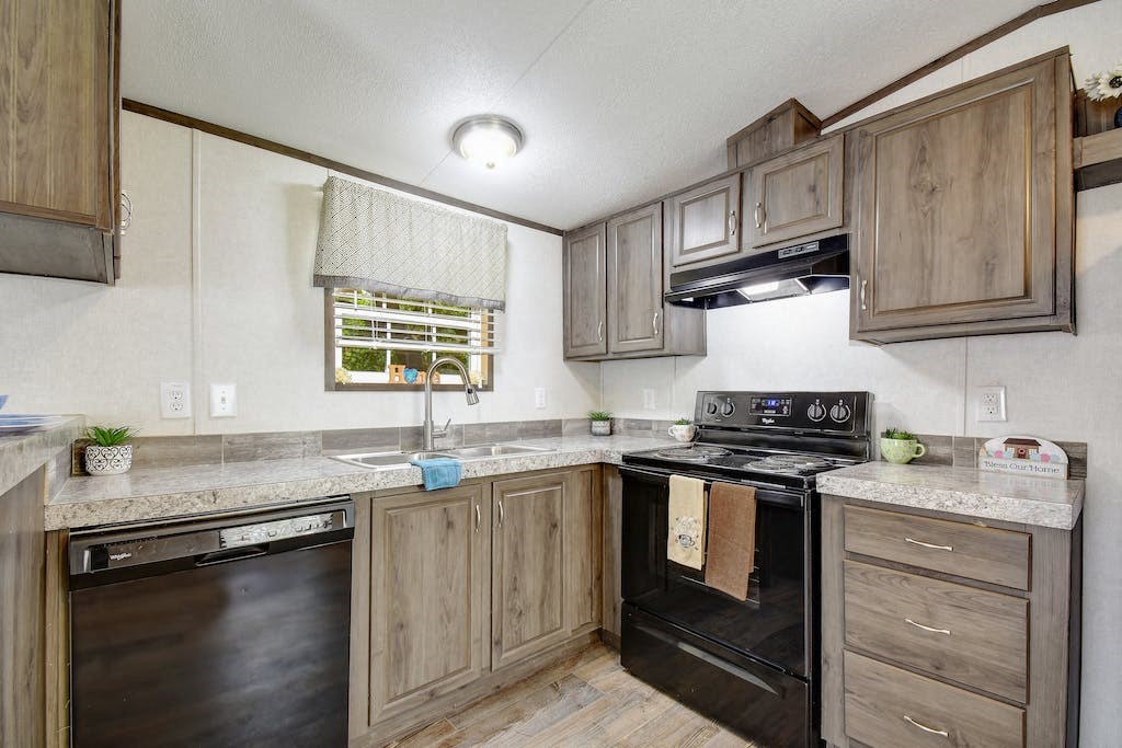 a kitchen with wooden cabinets and black appliances