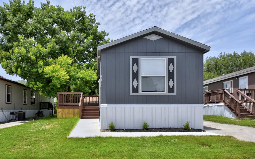 a gray house with a large window on the side of it at Regency Village in San Antonio, TX