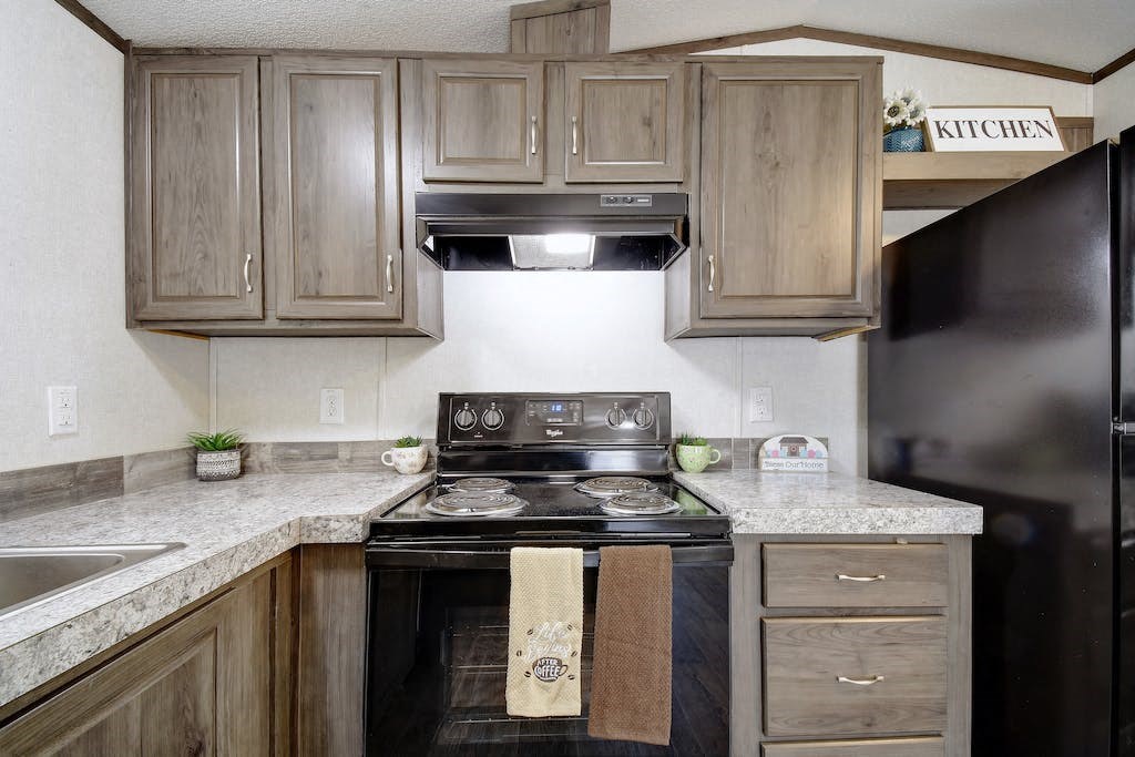 a kitchen with wooden cabinets and a black stove