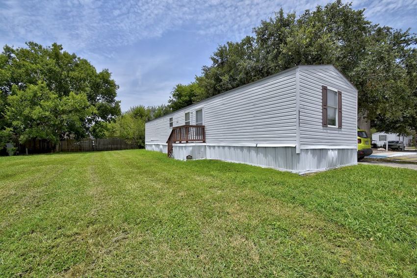 a small white house with a large yard in front of it a small white house with a large yard in front of it - Photo Gallery