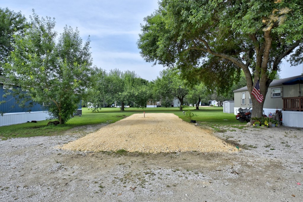 a large gravel parking lot in front of a house