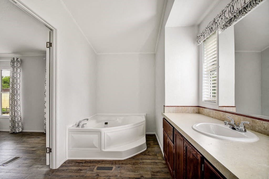 a bathroom with a bathtub and a sink