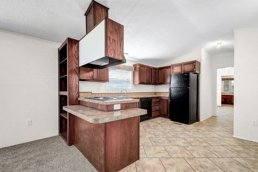 a kitchen with wooden cabinets and a black refrigerator a kitchen with wooden cabinets and a black refrigerator - Photo Gallery