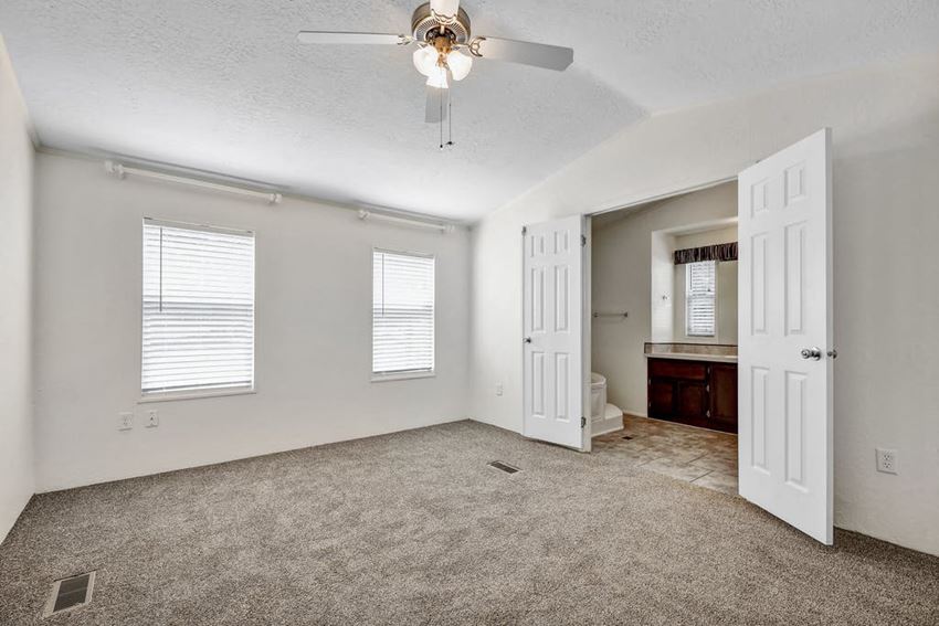 a bedroom with a ceiling fan and a bathroom in the background a bedroom with a ceiling fan and a bathroom in the background - Photo Gallery