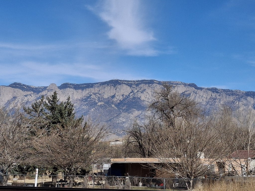 A mountain range with a building in the foreground.