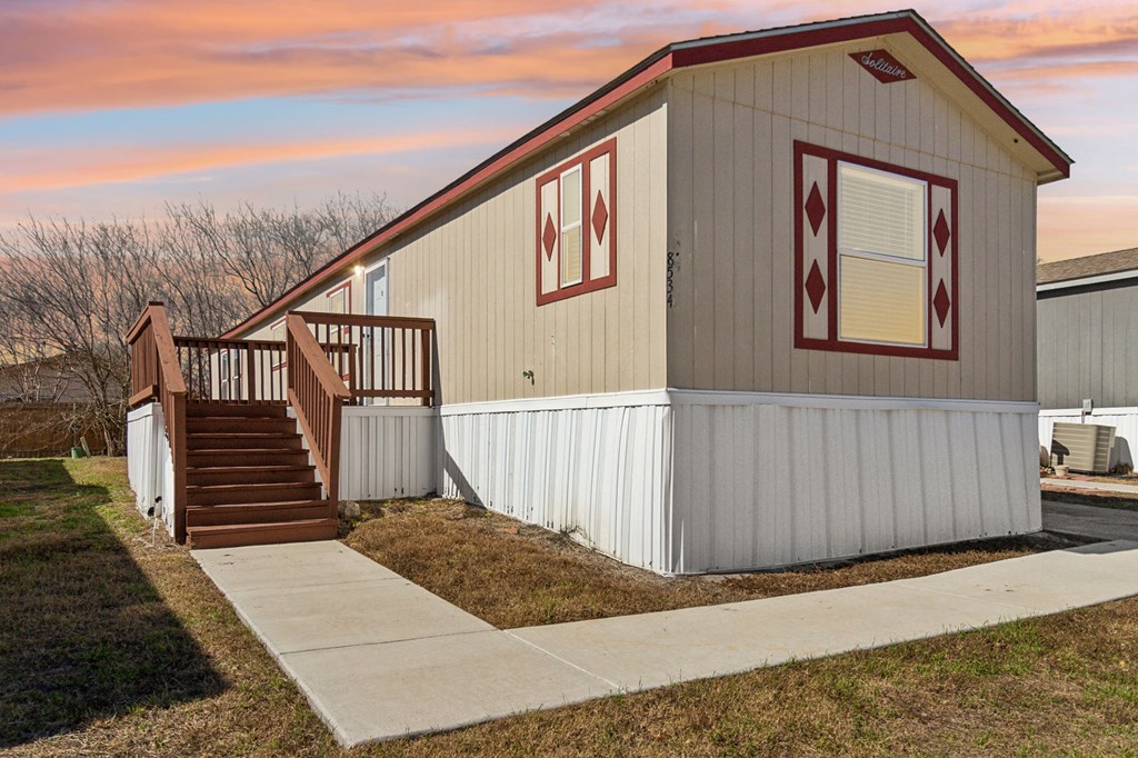 A small house with a red diamond pattern on the wall.