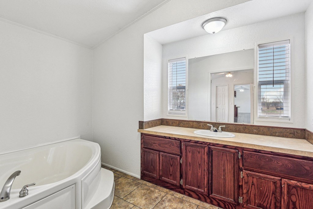 A white bathroom with a tub and sink.