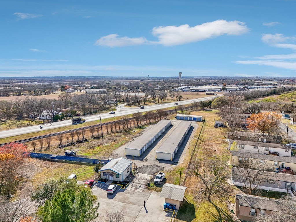A large industrial area with a long building and a parking lot.